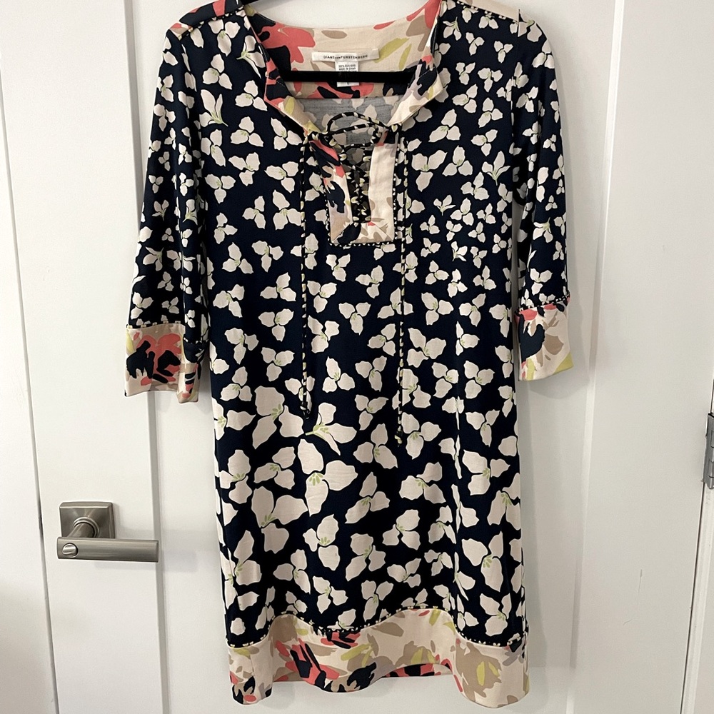 DVF resort dress. Navy print with colorful detail and tie at neck line.